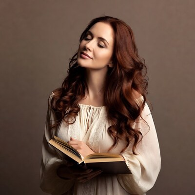 Woman reading book with eyes closed