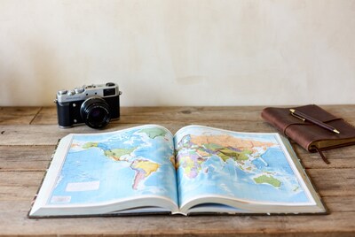 Open world map with camera and notebook