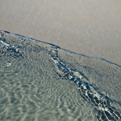 Ocean waves meeting sandy beach
