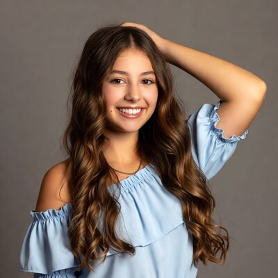 Smiling girl with hand in curly hair