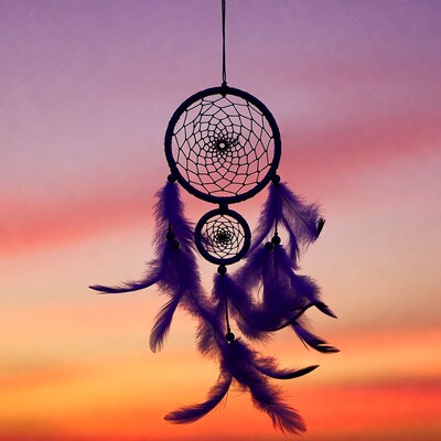 Dreamcatcher hanging against sunset sky