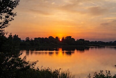 Sunset over lake with trees