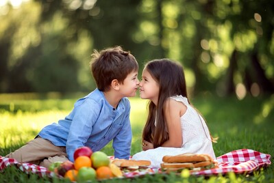 Boy and girl nose-to-nose at picnic