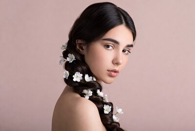 Woman with white flowers in braided hair