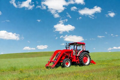 Red tractor in green field
