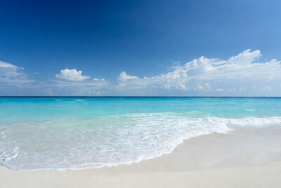 Turquoise ocean waves on white sand beach