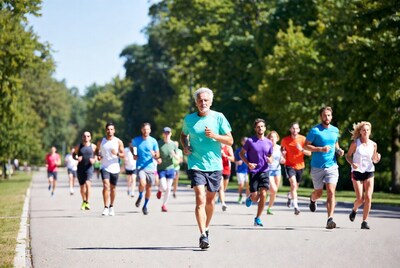 Group of runners jogging on tree-lined path