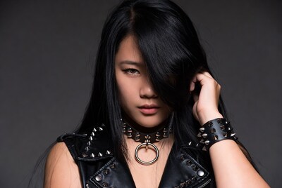 Asian woman in spiked leather goth outfit