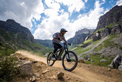 Man mountain biking in rocky valley