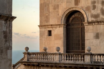 Stone Balcony with Arched Window Sunset