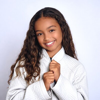 Smiling African-American girl in white jacket
