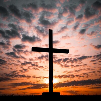 Silhouette cross at sunset