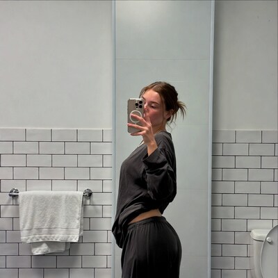 Woman taking mirror selfie in bathroom
