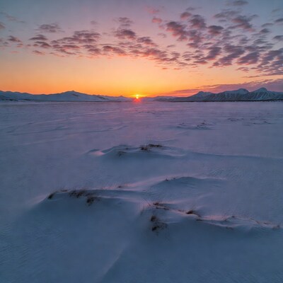 Sunrise over snowy landscape with mountains