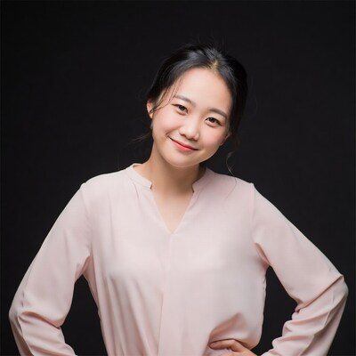 Asian woman smiling in pink blouse