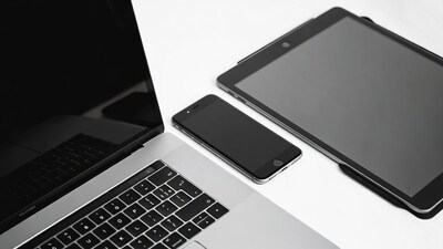 Laptop iPhone iPad on white surface