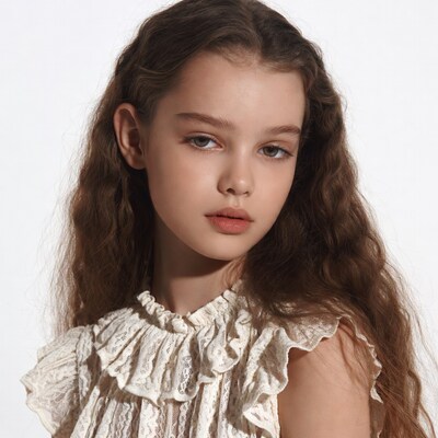 Girl with wavy brown hair in lace blouse