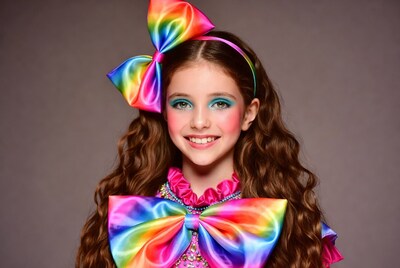 Girl with rainbow bow smiling