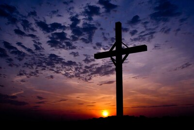Silhouette cross at sunset