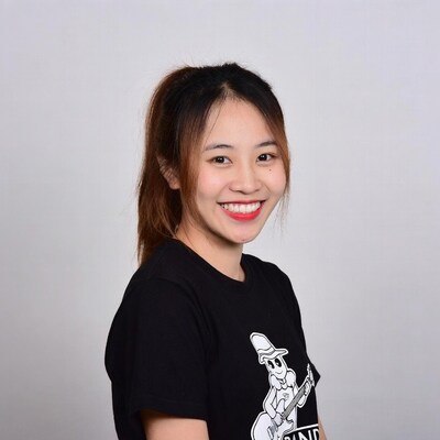 Asian woman smiling in band t-shirt