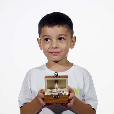 Boy holding open music box