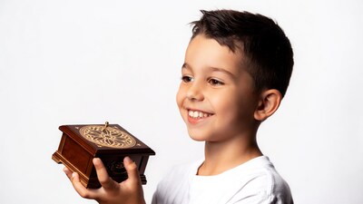 Boy holding wooden music box