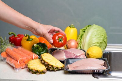 Woman hand picking tomato from groceries