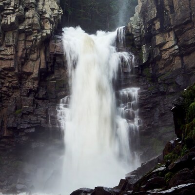 Majestic waterfall cascading between rocky cliffs