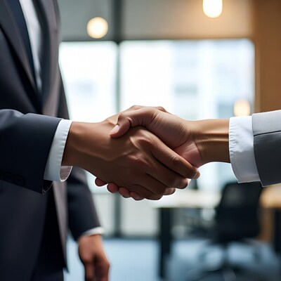 Businessman and businesswoman shaking hands
