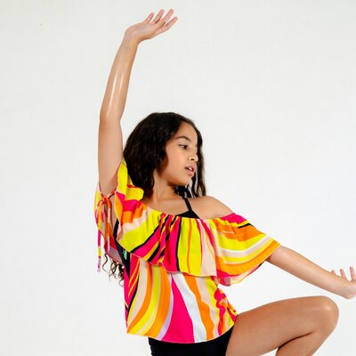 Girl dancing in colorful ruffle top