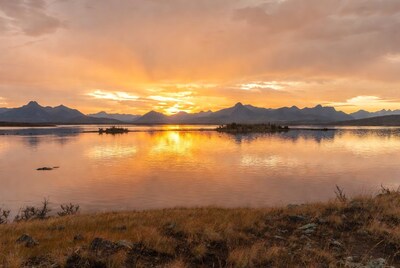 Sunset over mountains and lake