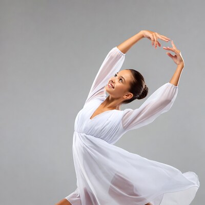Ballerina in white dress posing gracefully
