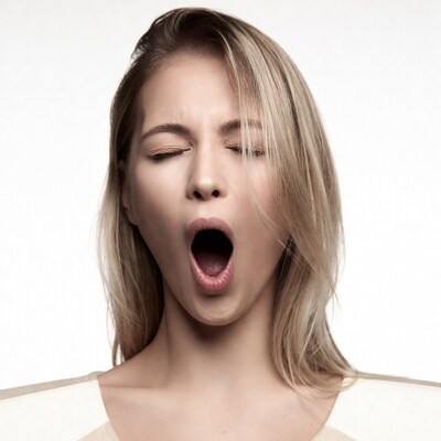 Blonde woman yawning wide mouth