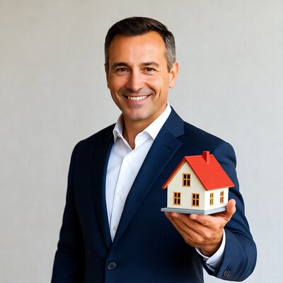 Man holding small house model