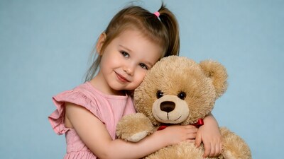 Girl hugging teddy bear