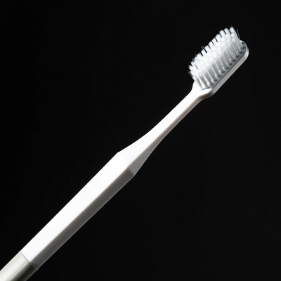 White toothbrush on black background