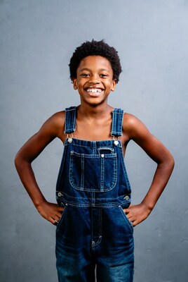 African-American boy smiling in denim overalls