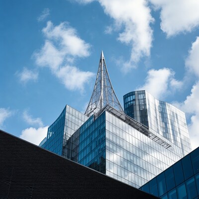 Modern skyscrapers with spire against blue sky