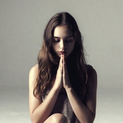 Woman praying with hands together