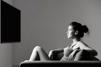 Woman lounging on couch near TV