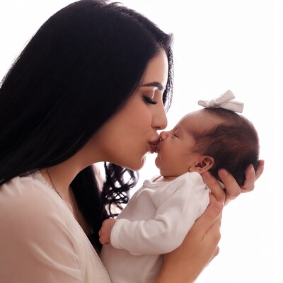 Mother kissing newborn baby