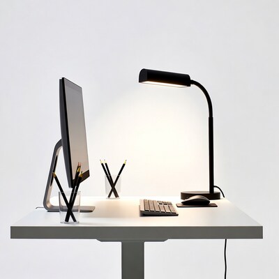 Modern desk with computer monitor and lamp