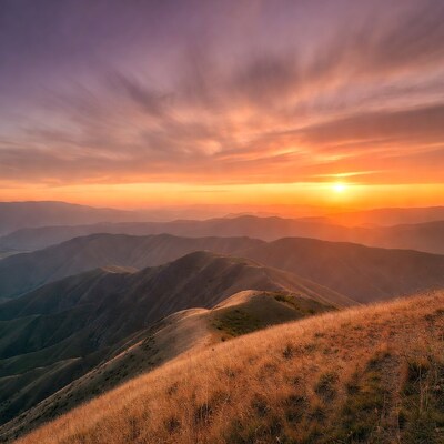 Sunset over rolling mountains