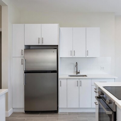 Modern white kitchen with stainless steel appliances