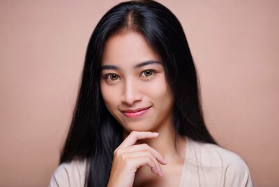 Asian woman hand on chin smiling