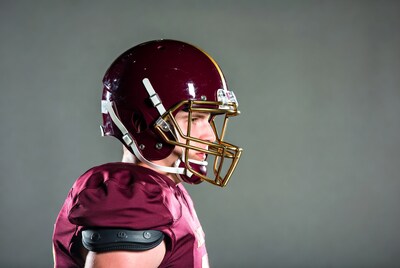 Football player in maroon helmet profile