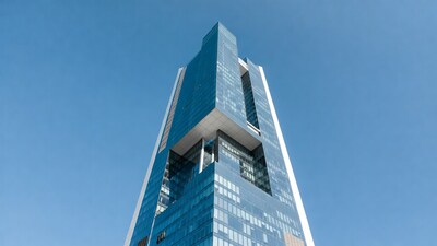 Modern glass skyscraper against blue sky