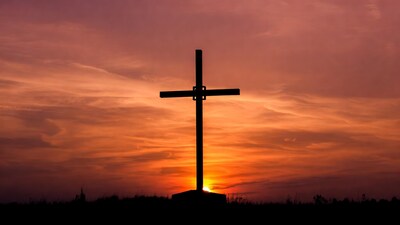 Silhouette cross at sunset