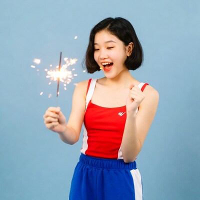 Asian girl holding lit sparkler
