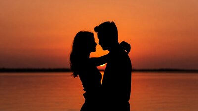 Silhouette couple embracing at sunset